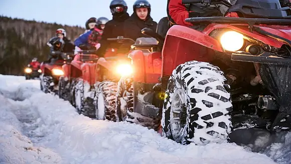 group-of-people-driving-quad-bikes-on-snowy-road2